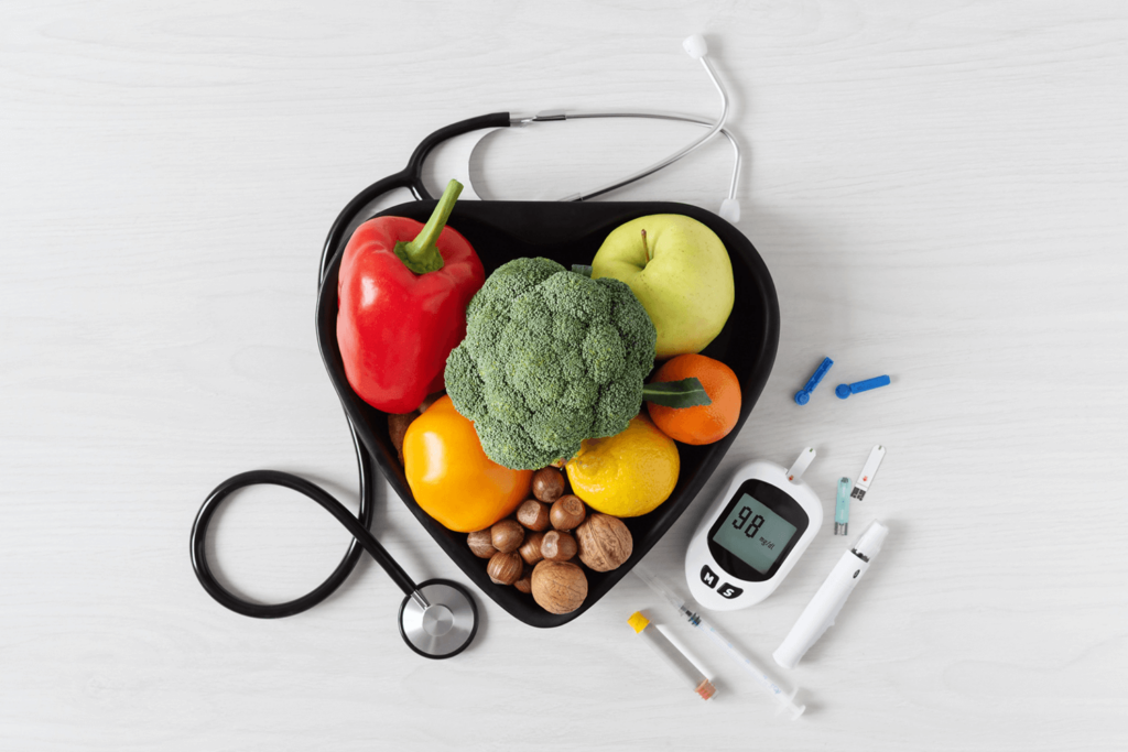 Fresh vegetables and fruit with glucometer top view on white wooden background. 