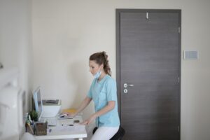 Nurse checking a device on the computer